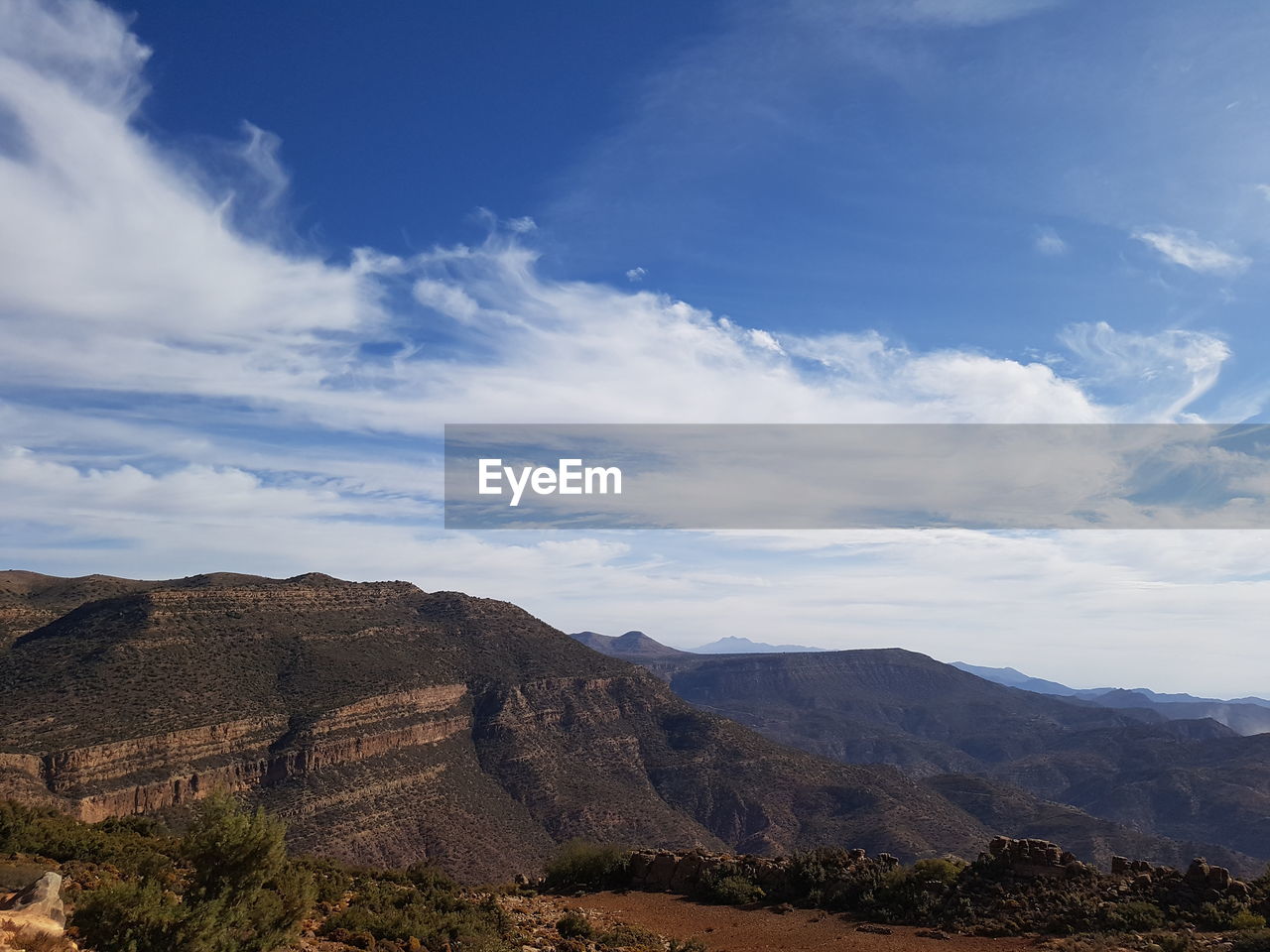 Scenic view of mountains against cloudy sky