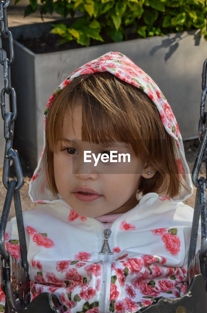 child, childhood, portrait, one person, female, women, front view, clothing, spring, innocence, cute, looking at camera, person, baby, headshot, day, hairstyle, emotion, toddler, nature, outdoors, brown hair, dress, playground, human face, smiling