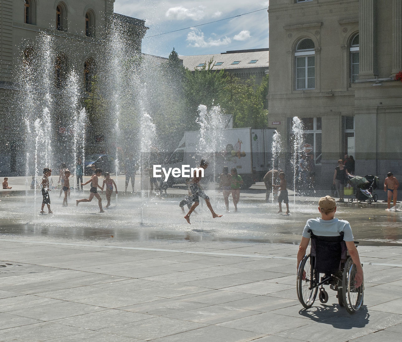 People playing in city fountain