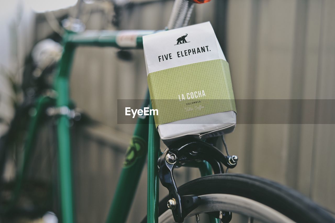 CLOSE-UP OF BICYCLE WITH SIGN ON MOTORCYCLE