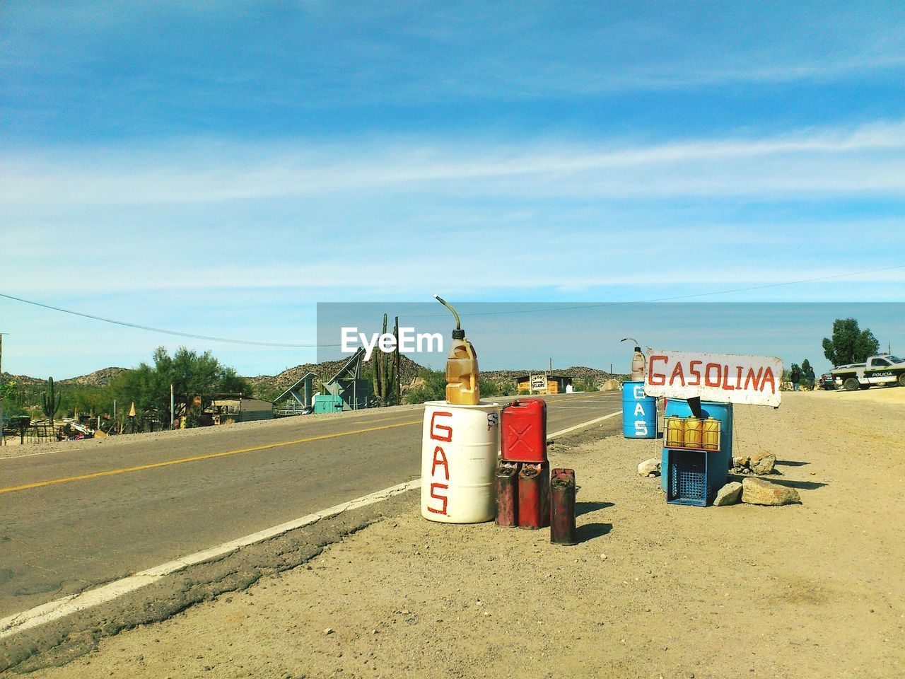 Gasoline cans by empty road