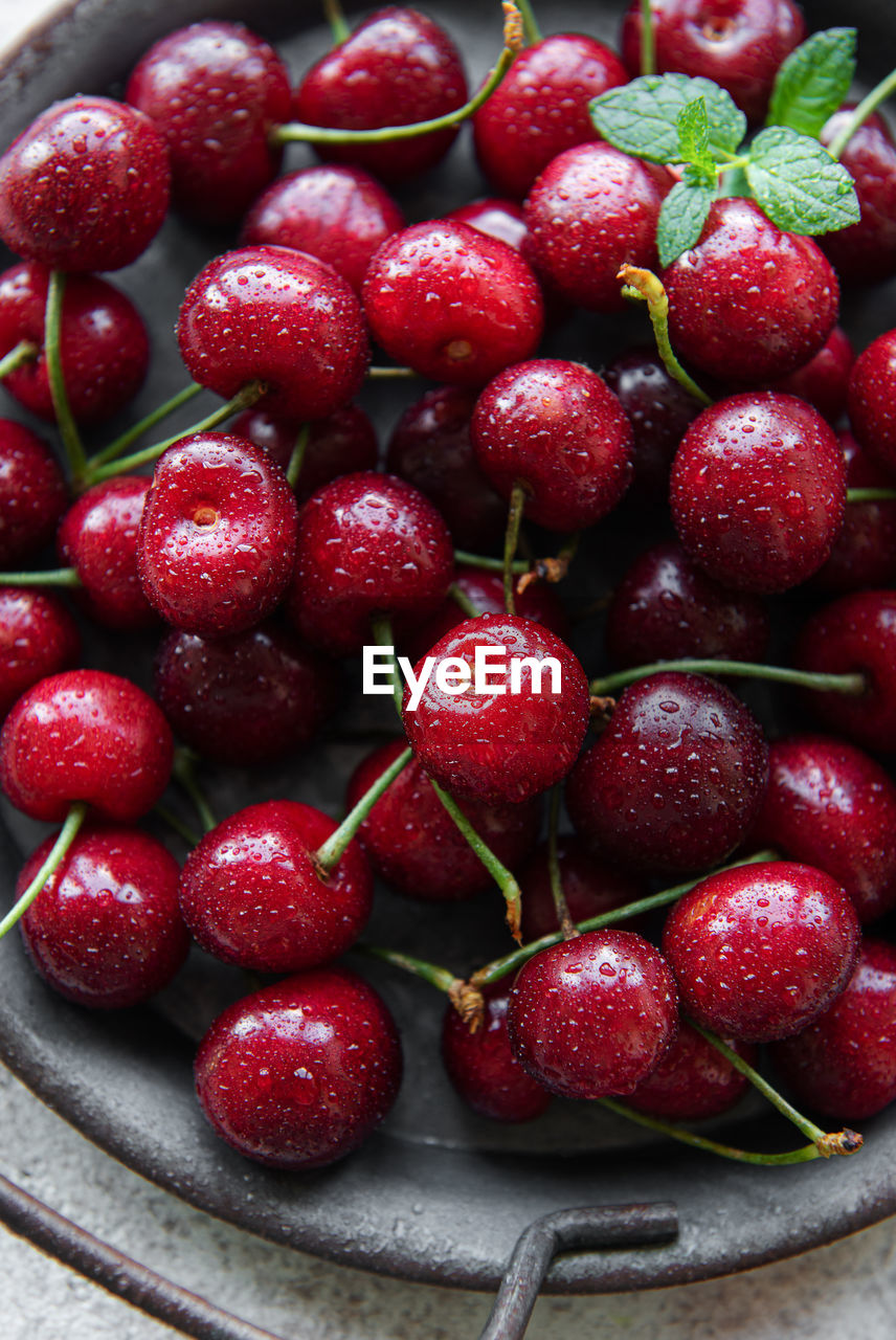 Fresh red cherries fruit on a concrete background