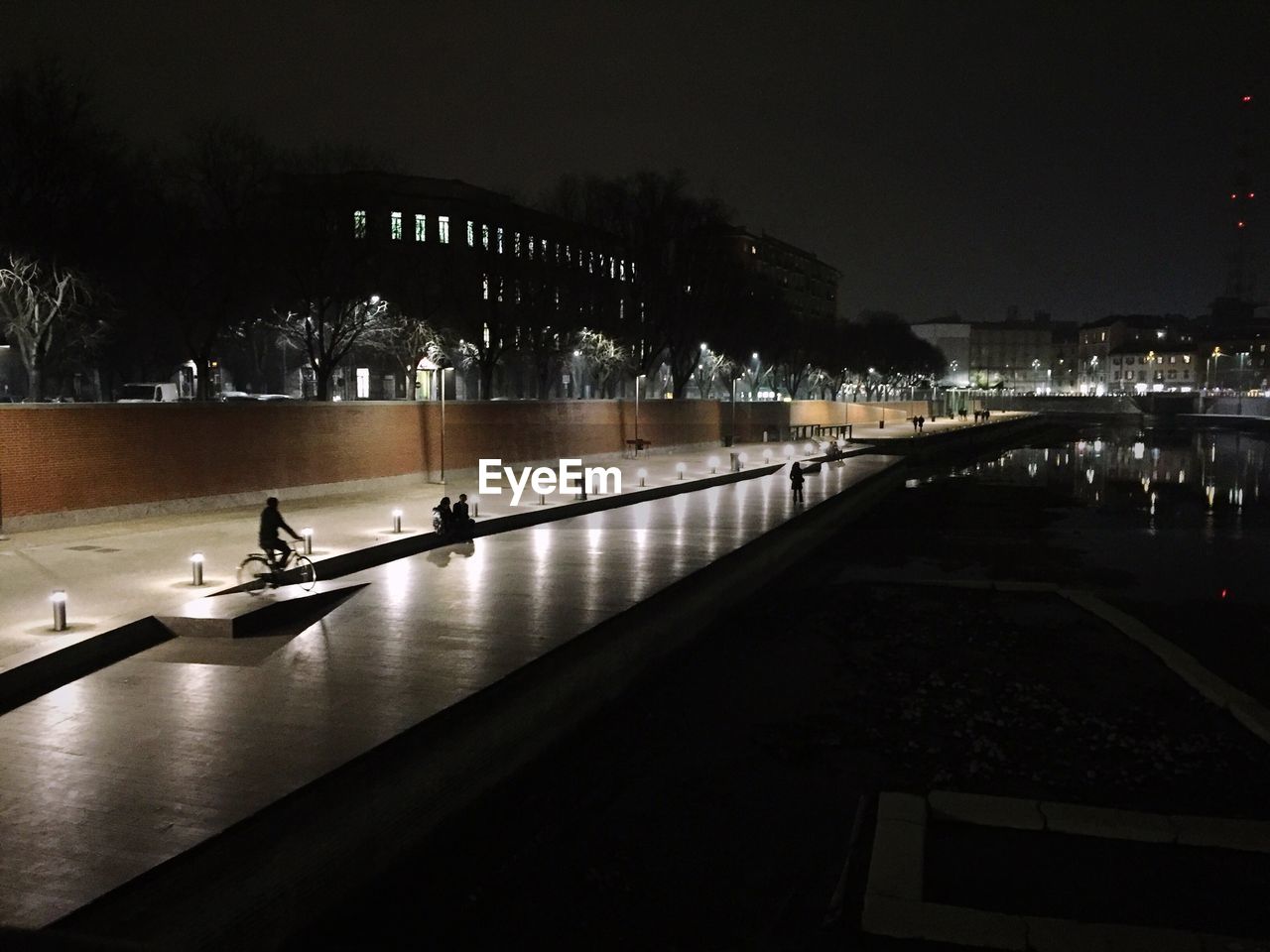 VIEW OF ILLUMINATED CITY AT NIGHT