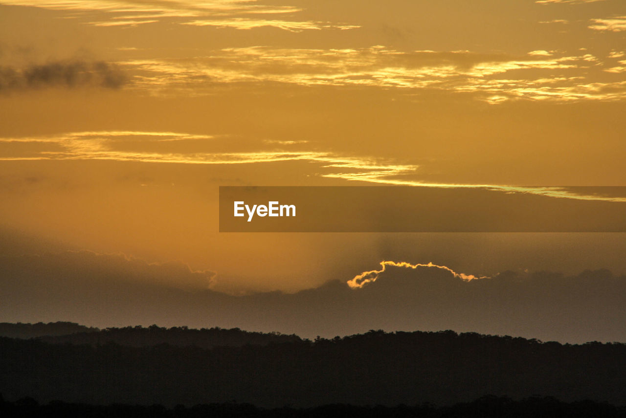 Scenic view of silhouette landscape against sky at sunset