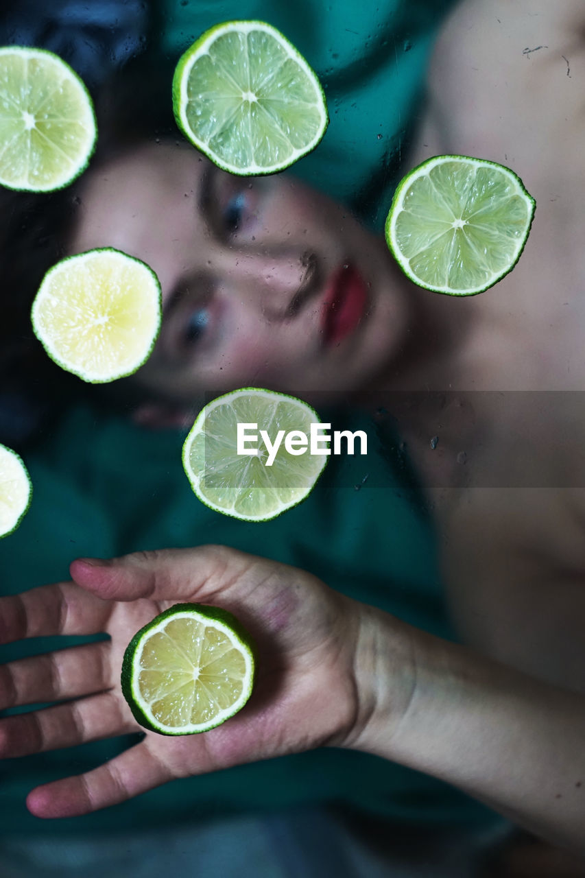 Cropped hand of woman holding plant