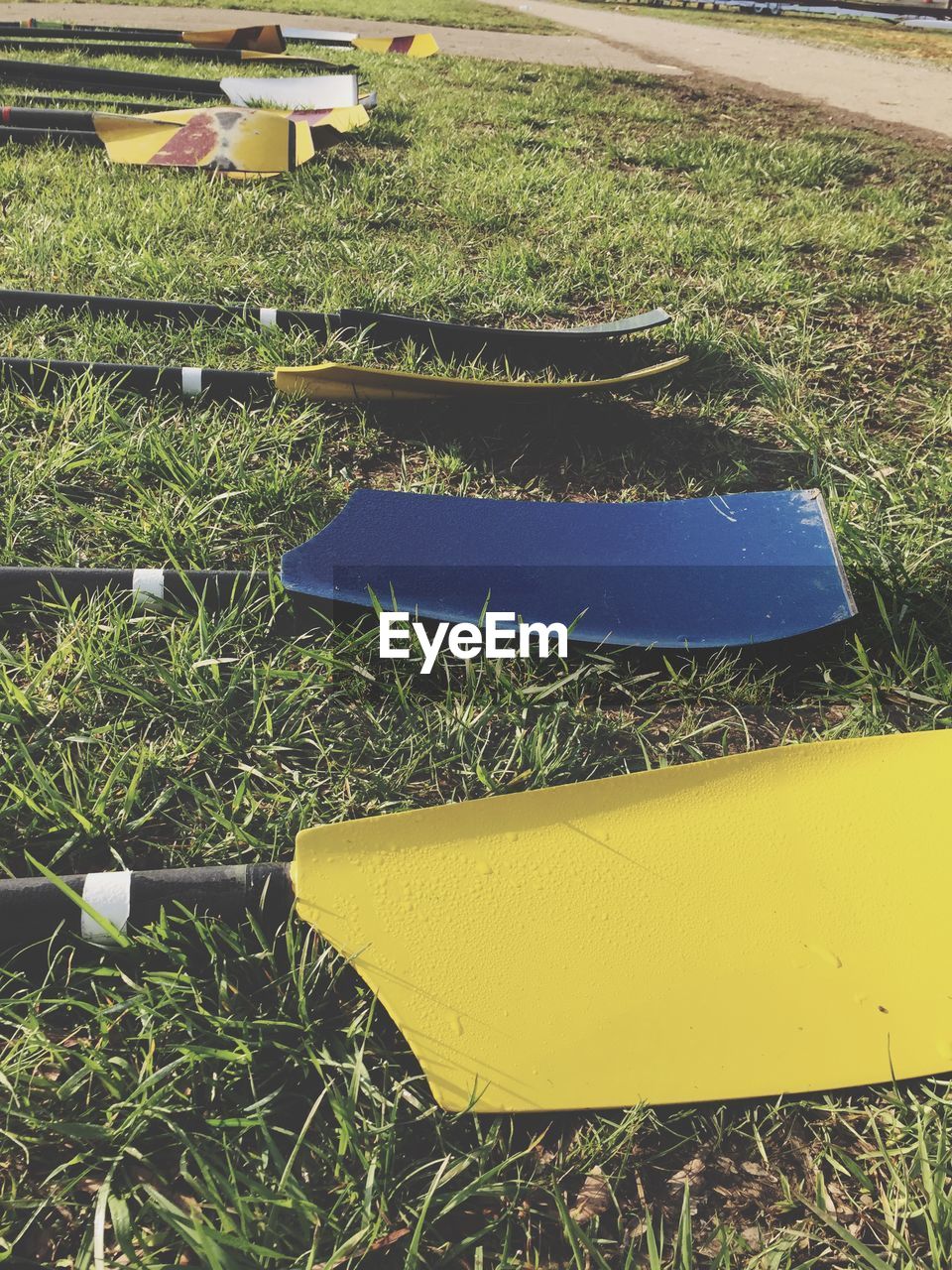 High angle view of oars on grassy field