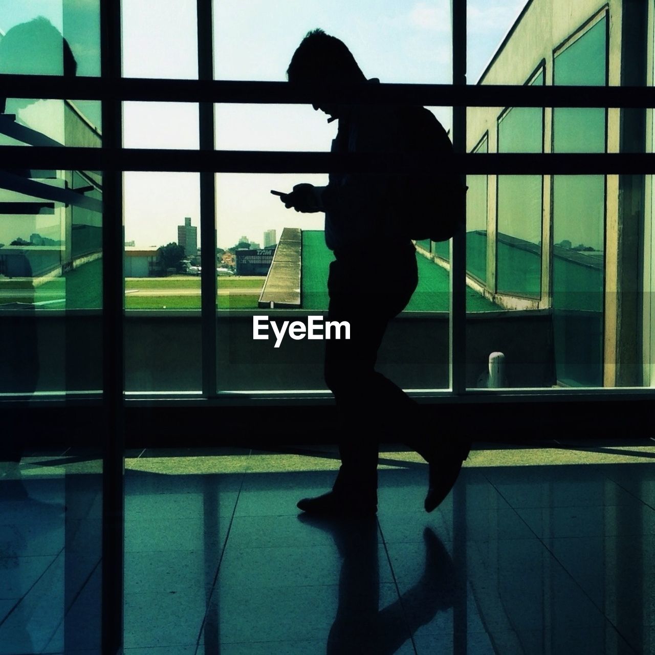 Silhouette man walking in modern building