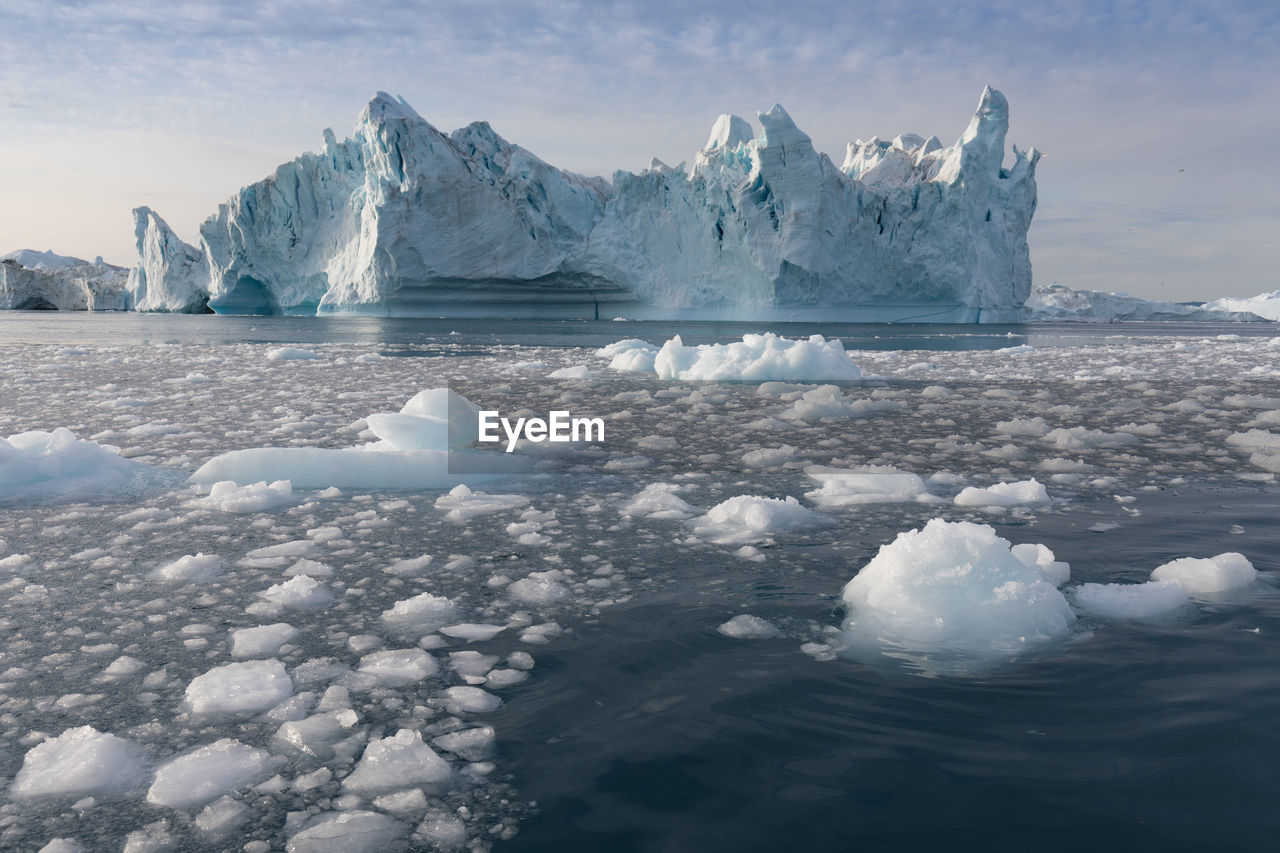 ICE FLOATING ON WATER IN WINTER AGAINST SKY