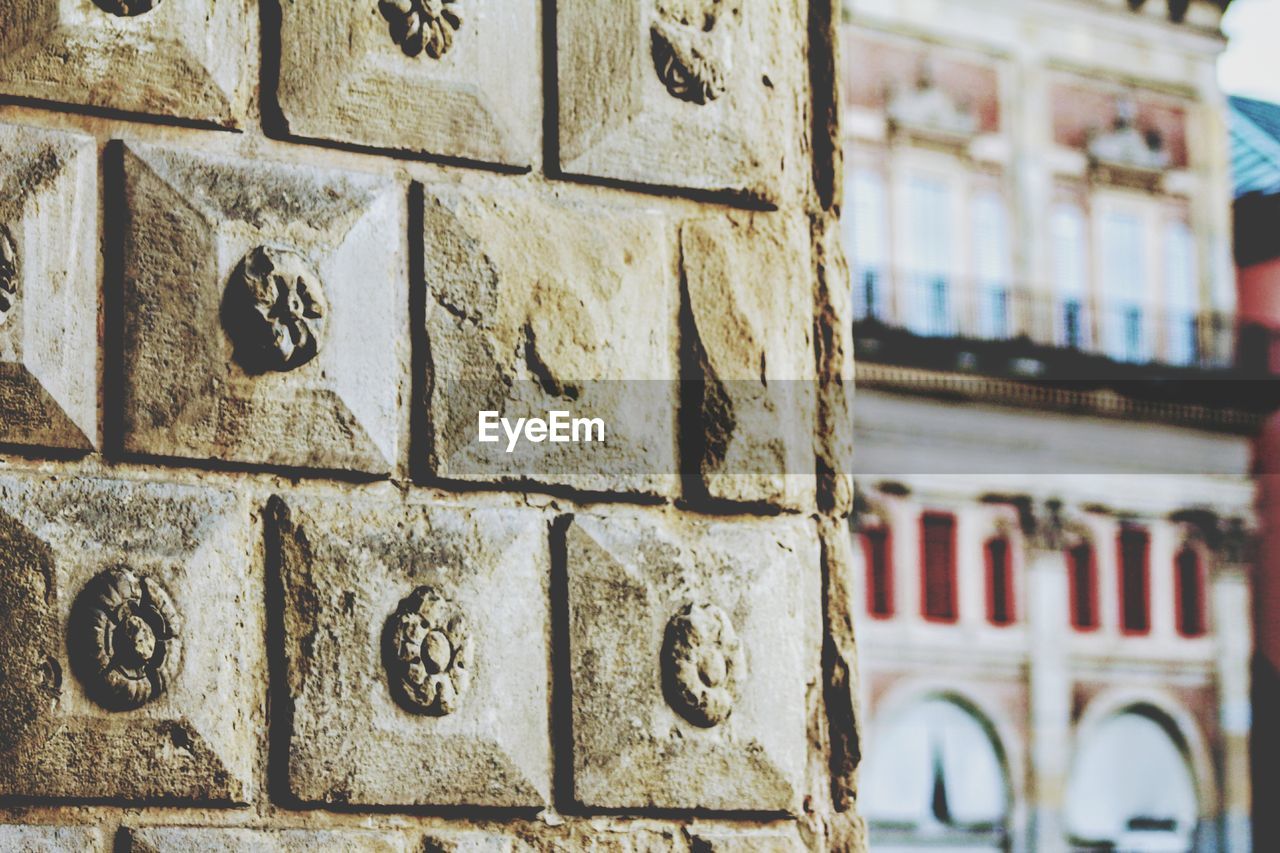 Low angle view of stone wall against building