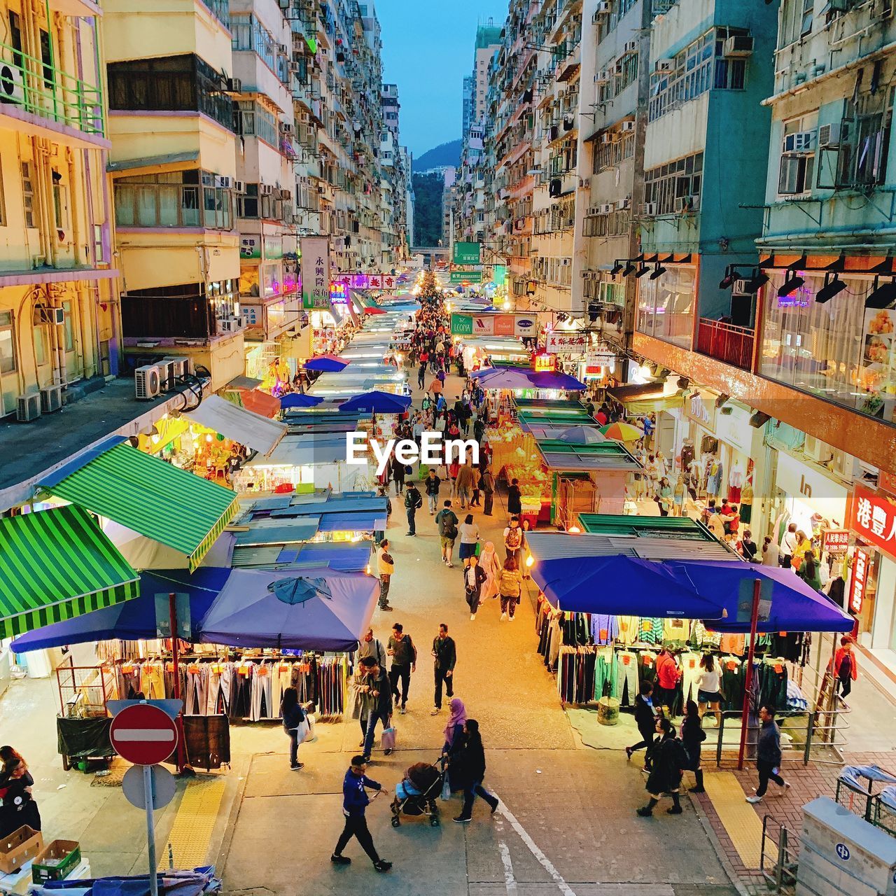 High angle view of people at night street market in city