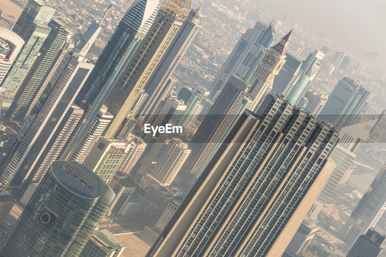 HIGH ANGLE VIEW OF MODERN CITY BUILDINGS AGAINST SKY