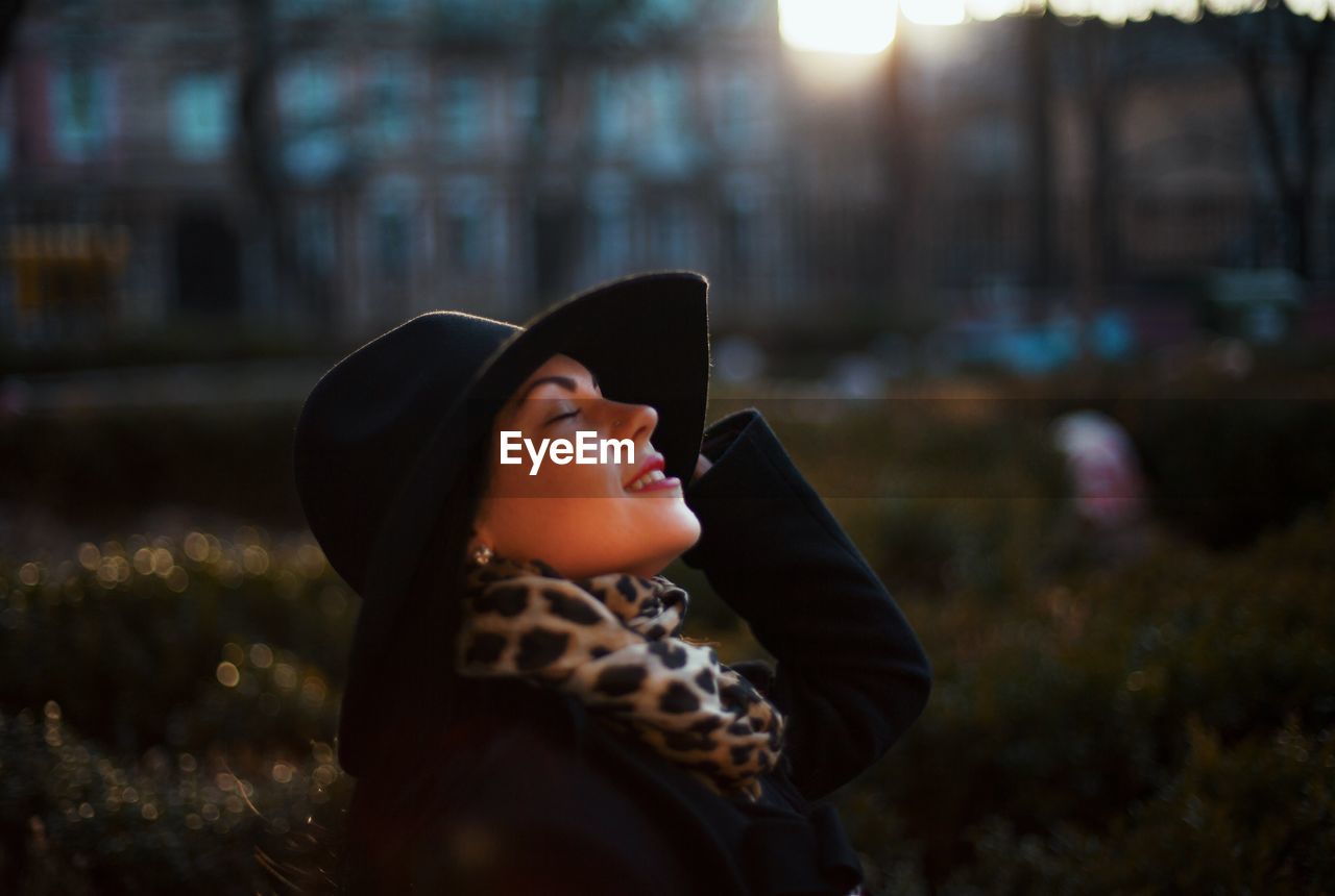 Close-up of young woman with closed eyes standing at park