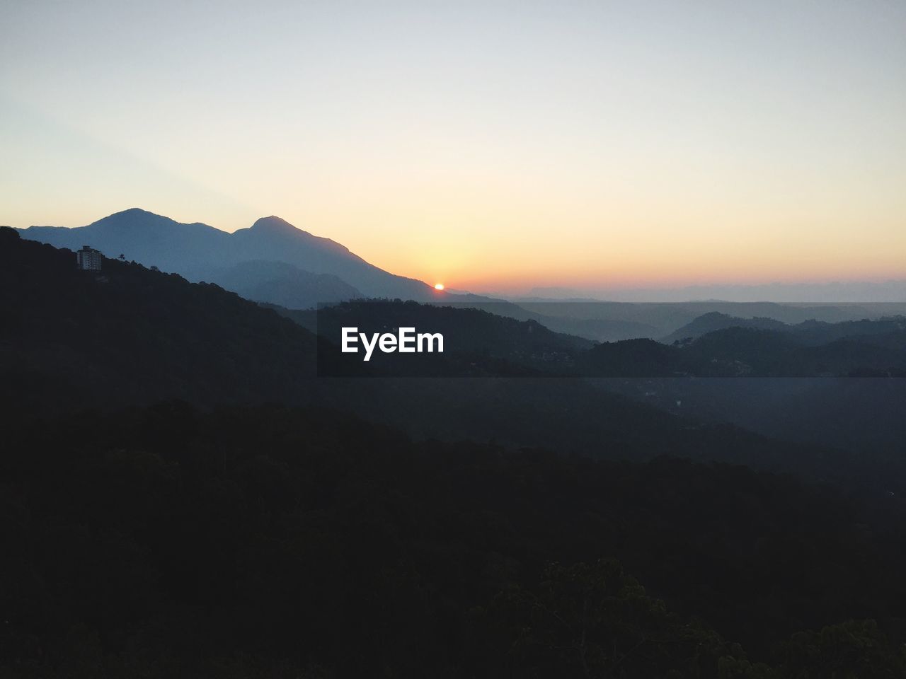 Scenic view of silhouette mountains against clear sky