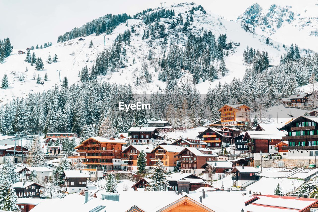 Aerial view of snow covered houses and buildings in city