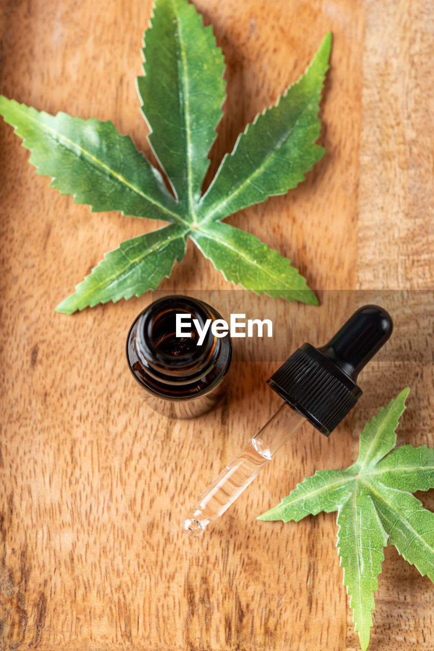 Pharmaceutical cbd oil and cannabis tincture on a wooden background. concept of medical marijuana 