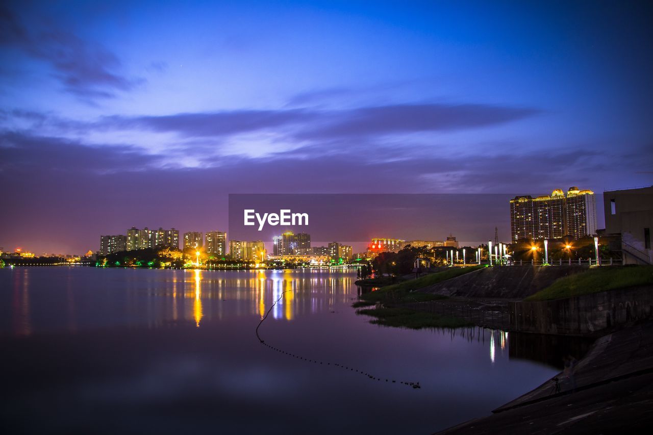 Reflection of illuminated buildings in water at dusk