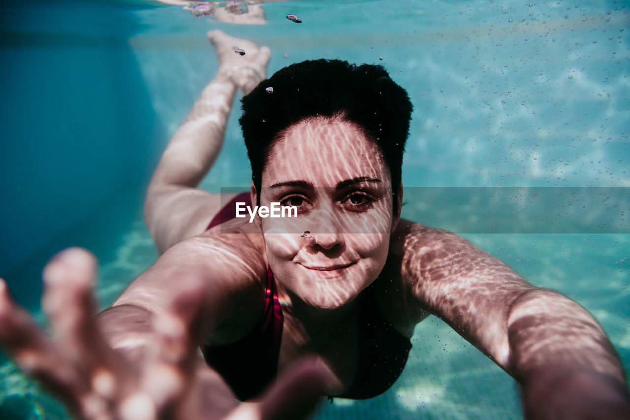 Portrait of woman swimming in pool