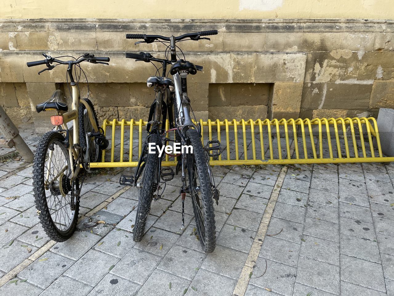 BICYCLE LEANING AGAINST WALL