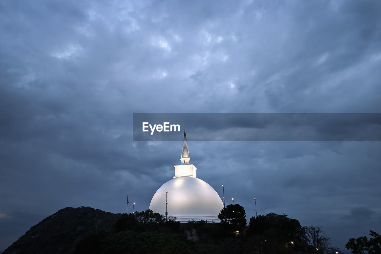 Low angle view of a building against cloudy sky