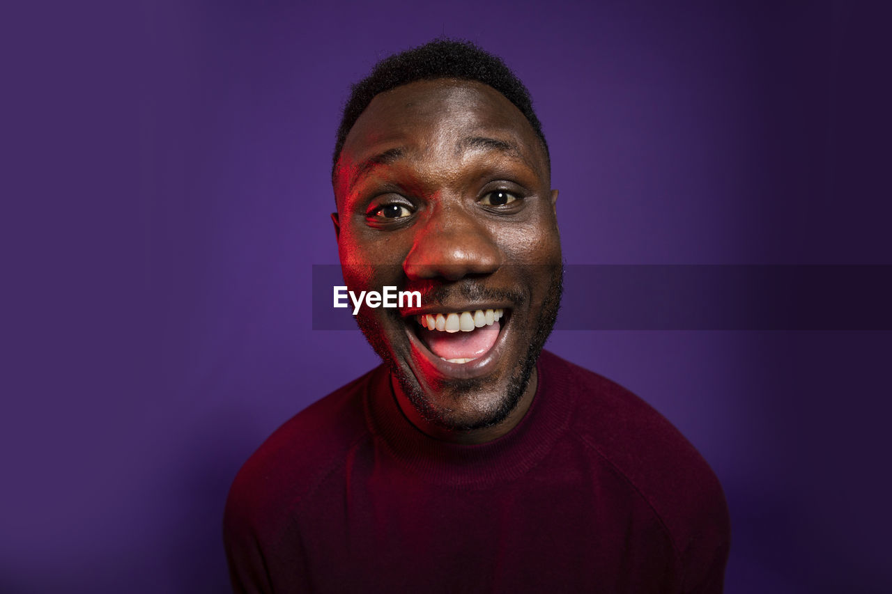 Portrait of smiling man against blue background