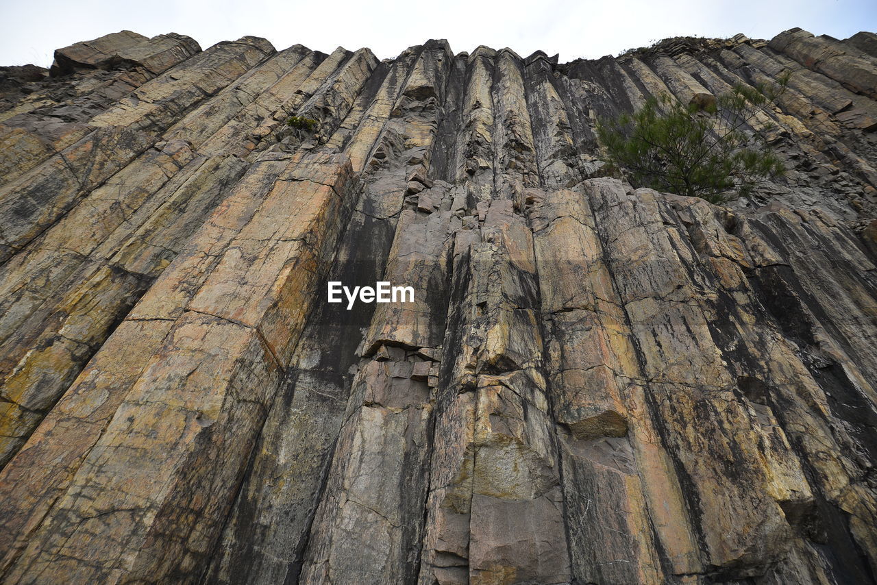 LOW ANGLE VIEW OF ROCK FORMATIONS AGAINST SKY