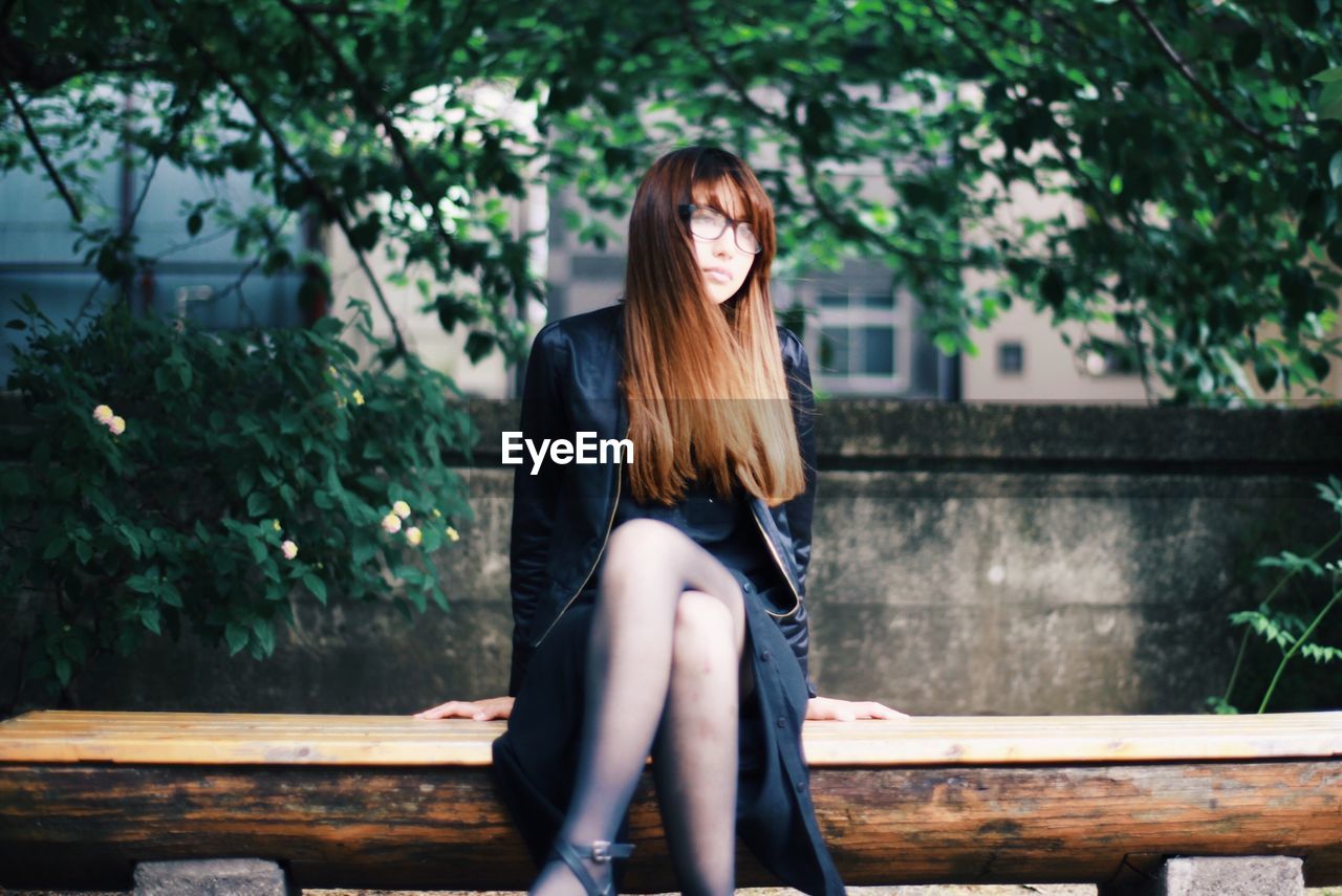 WOMAN SITTING ON BENCH