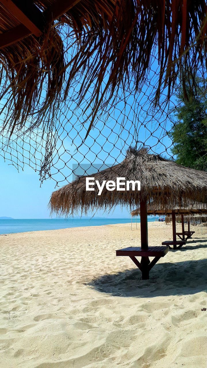 Sunshade on beach against sky