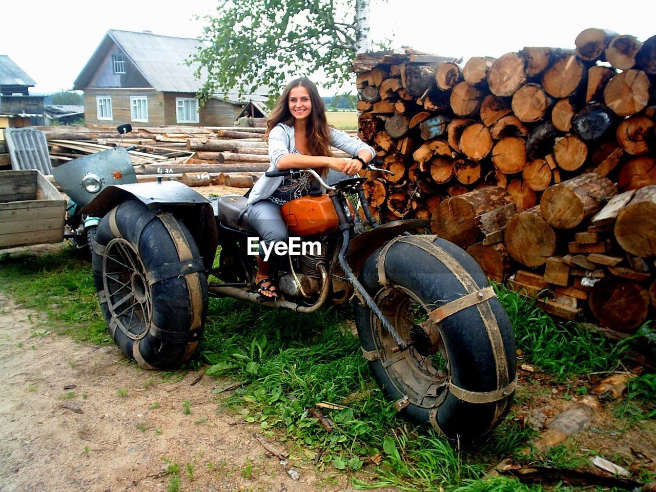 PORTRAIT OF WOMAN SITTING ON CART