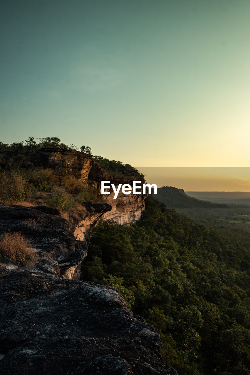 Scenic view of landscape against clear sky during sunset