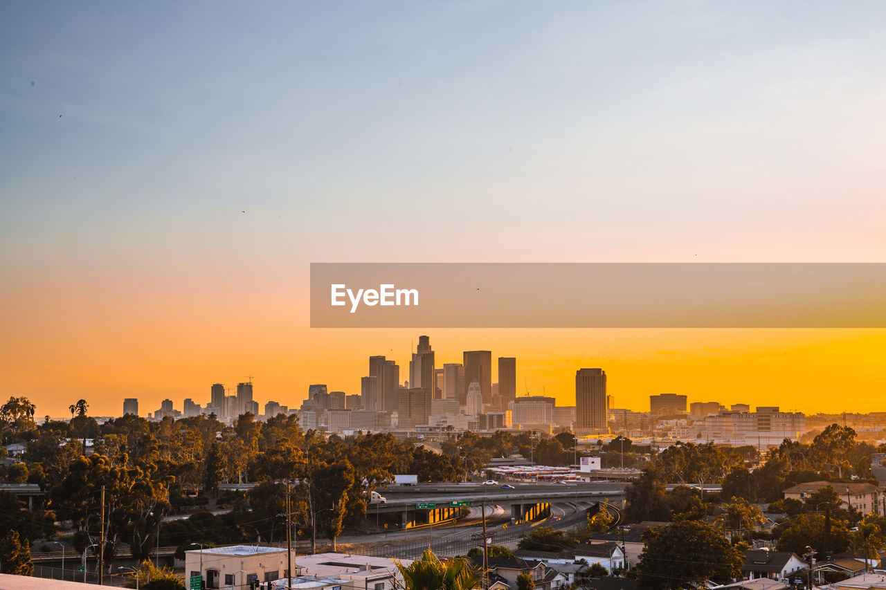 Aerial view of cityscape against sky during sunset