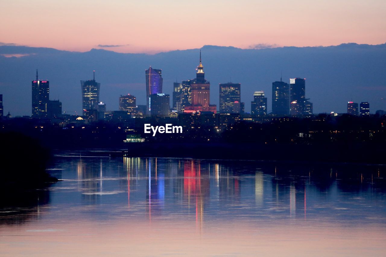 River leading towards illuminated city at night