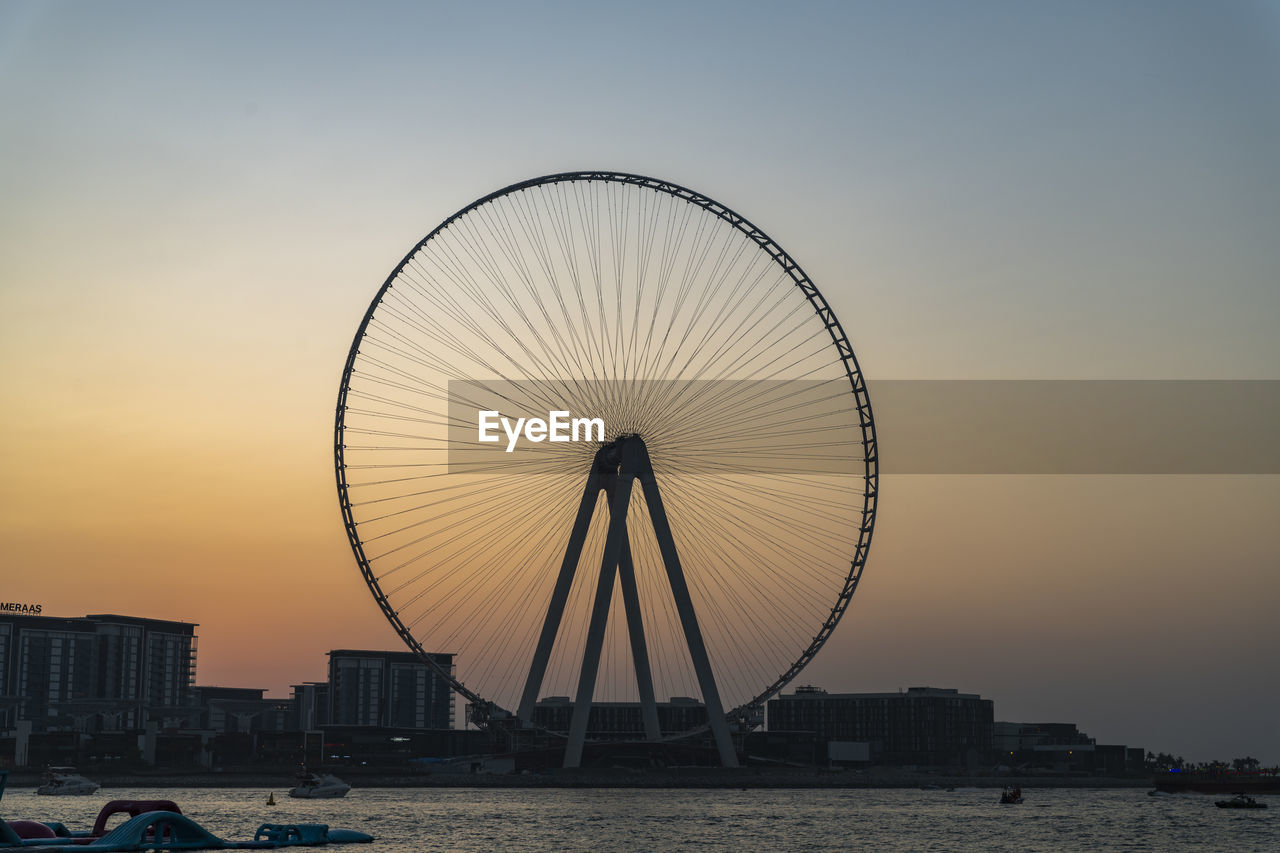 FERRIS WHEEL IN CITY AGAINST CLEAR SKY