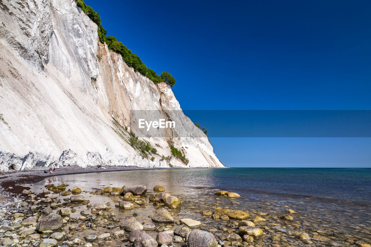 Scenic view of sea against clear blue sky