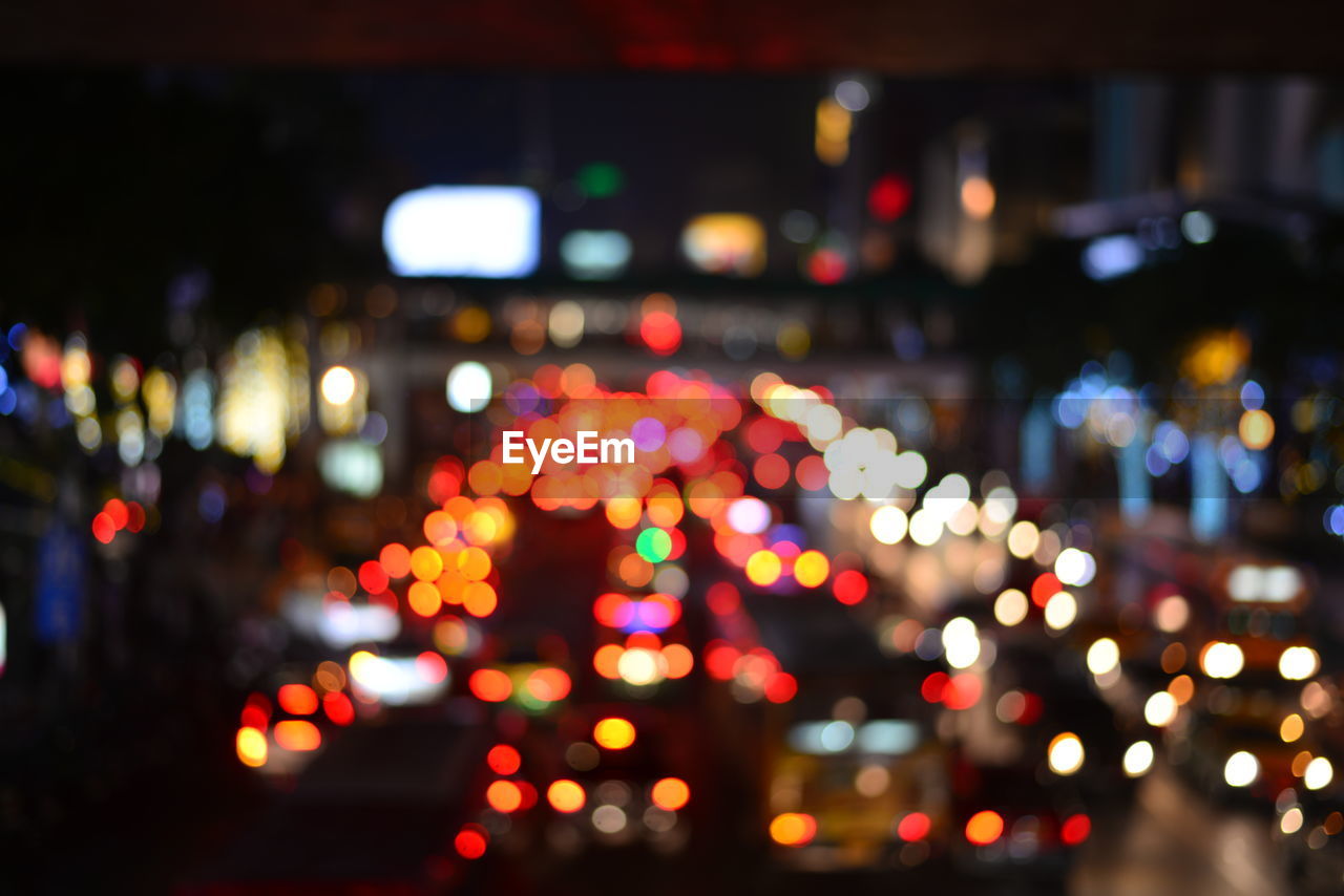 Defocused image of illuminated city at night