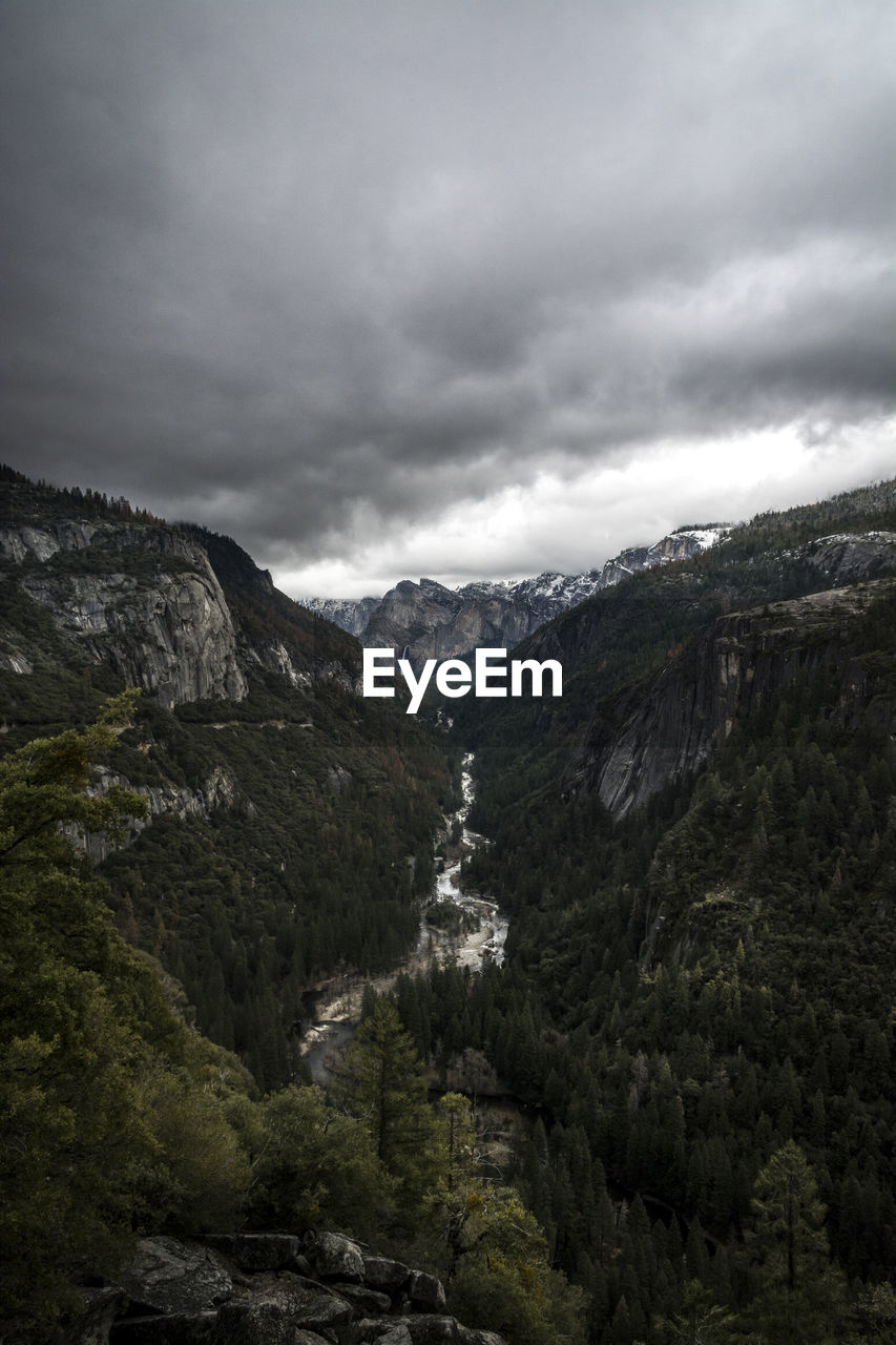 Scenic view of mountains against cloudy sky