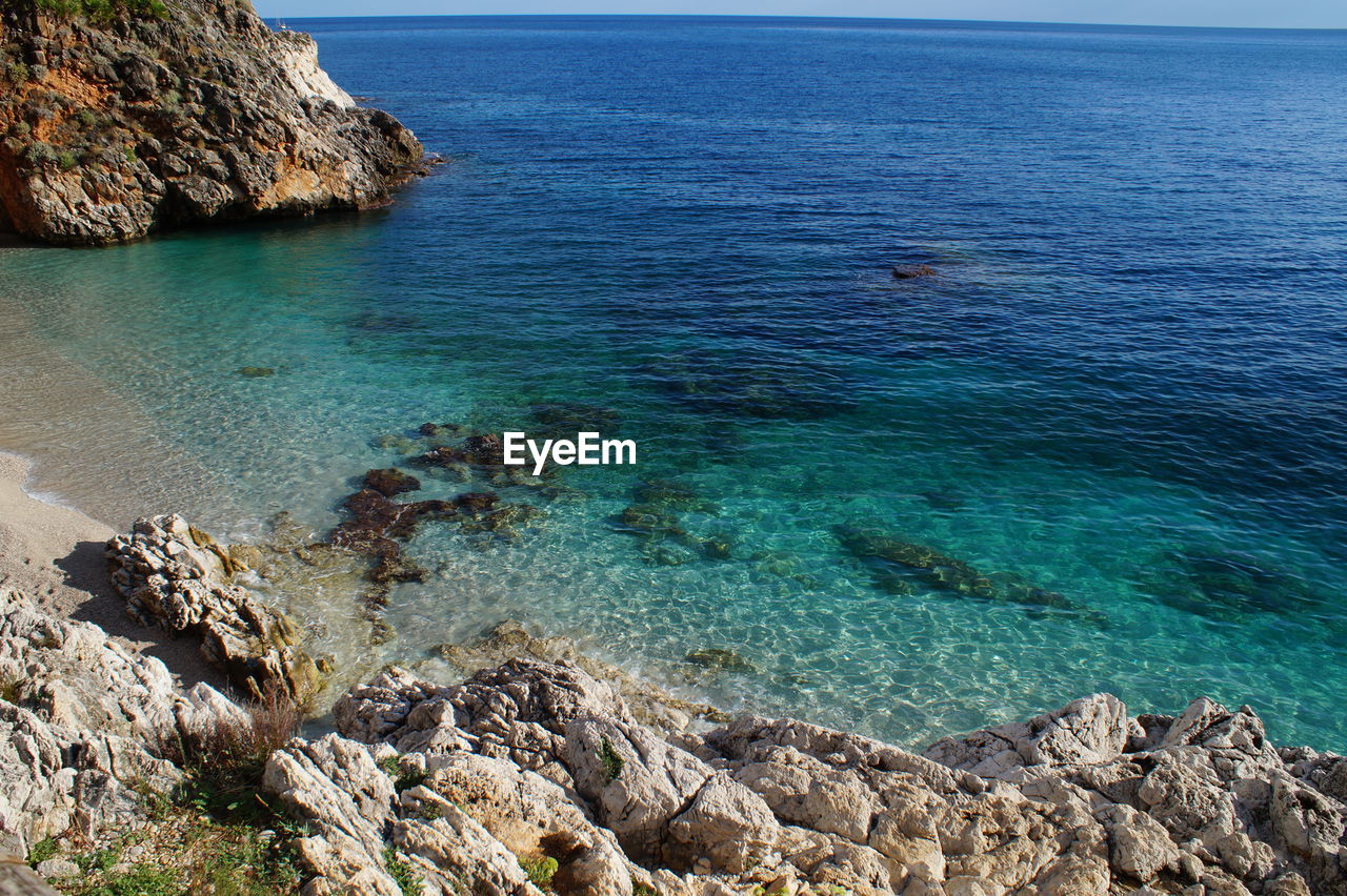 High angle view of sea against blue sky