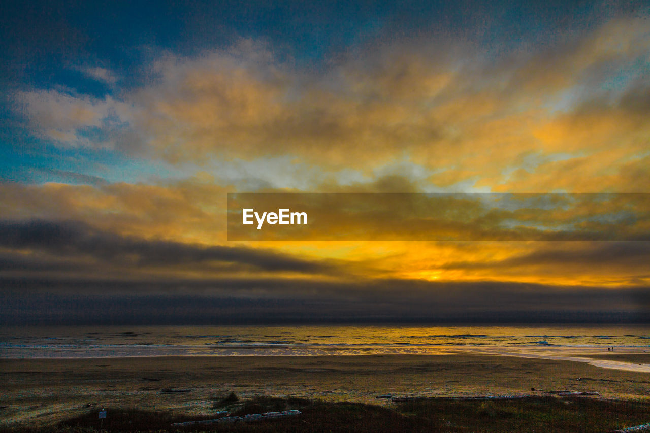 Scenic view of dramatic sky over sea during sunset