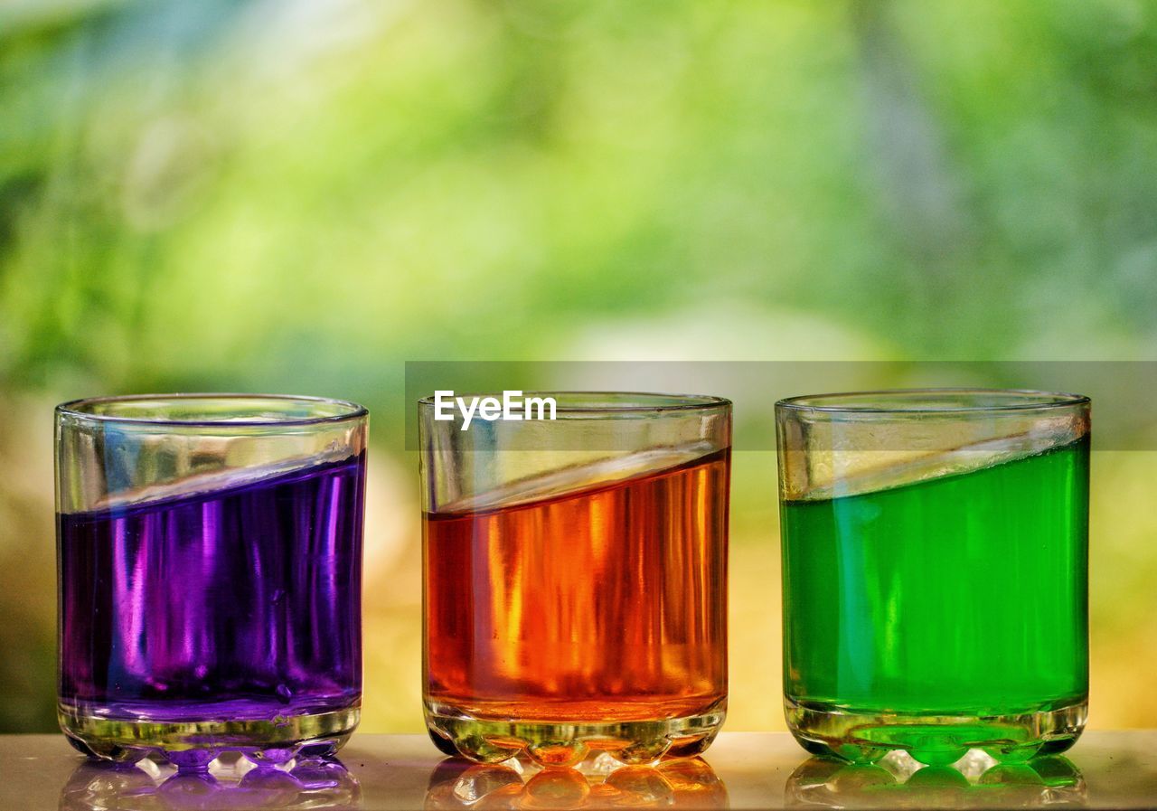 Close-up of multi colored drinks in glass