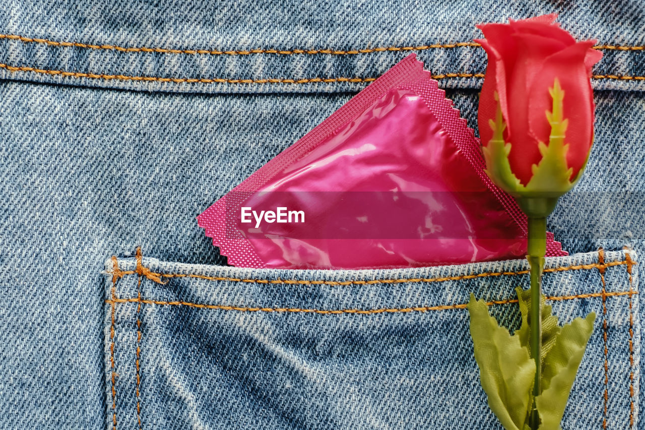 Close-up view of rose with packet in pocket