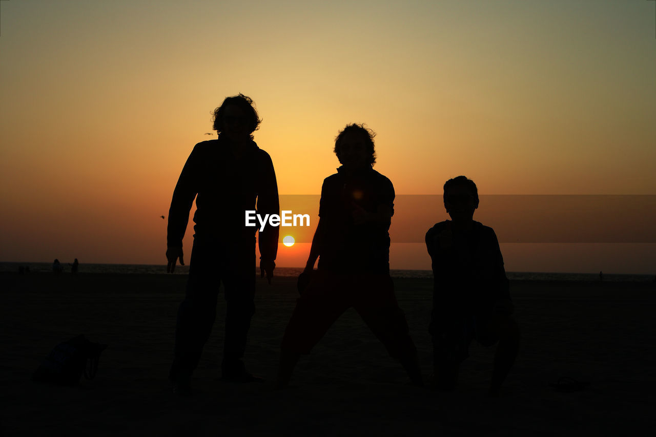 SILHOUETTE PEOPLE AT BEACH DURING SUNSET