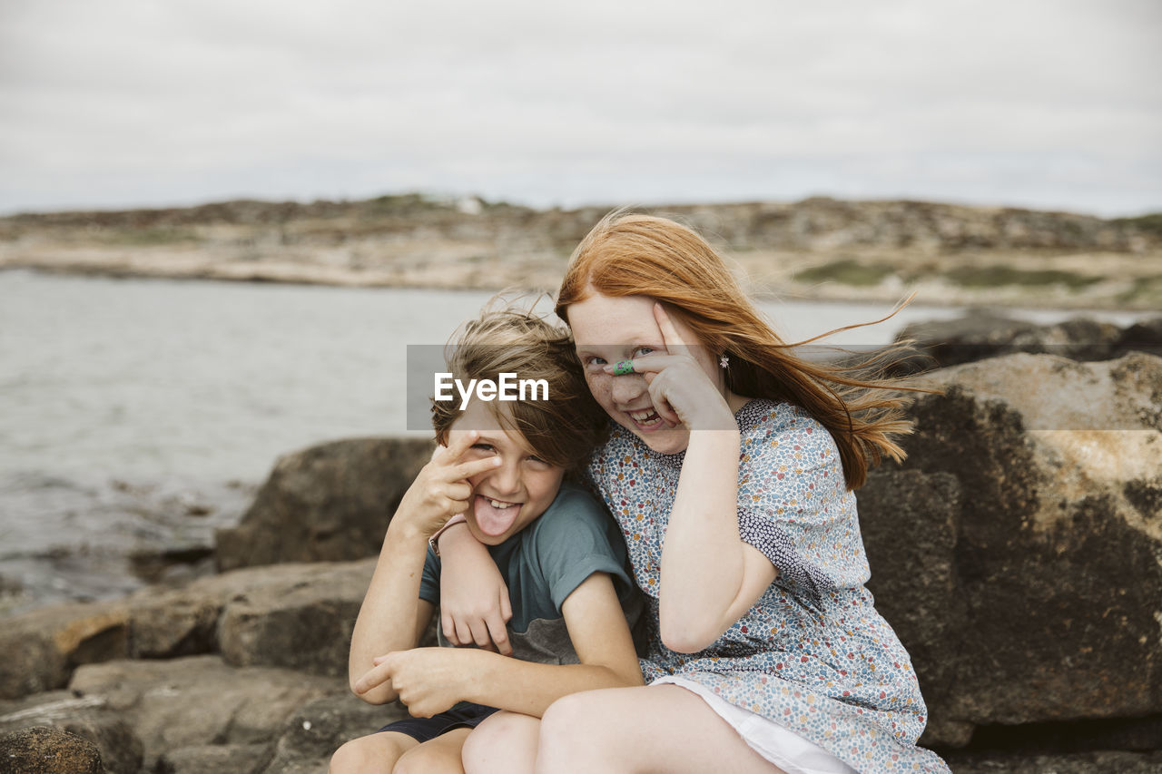 Brother and sister playing at seaside