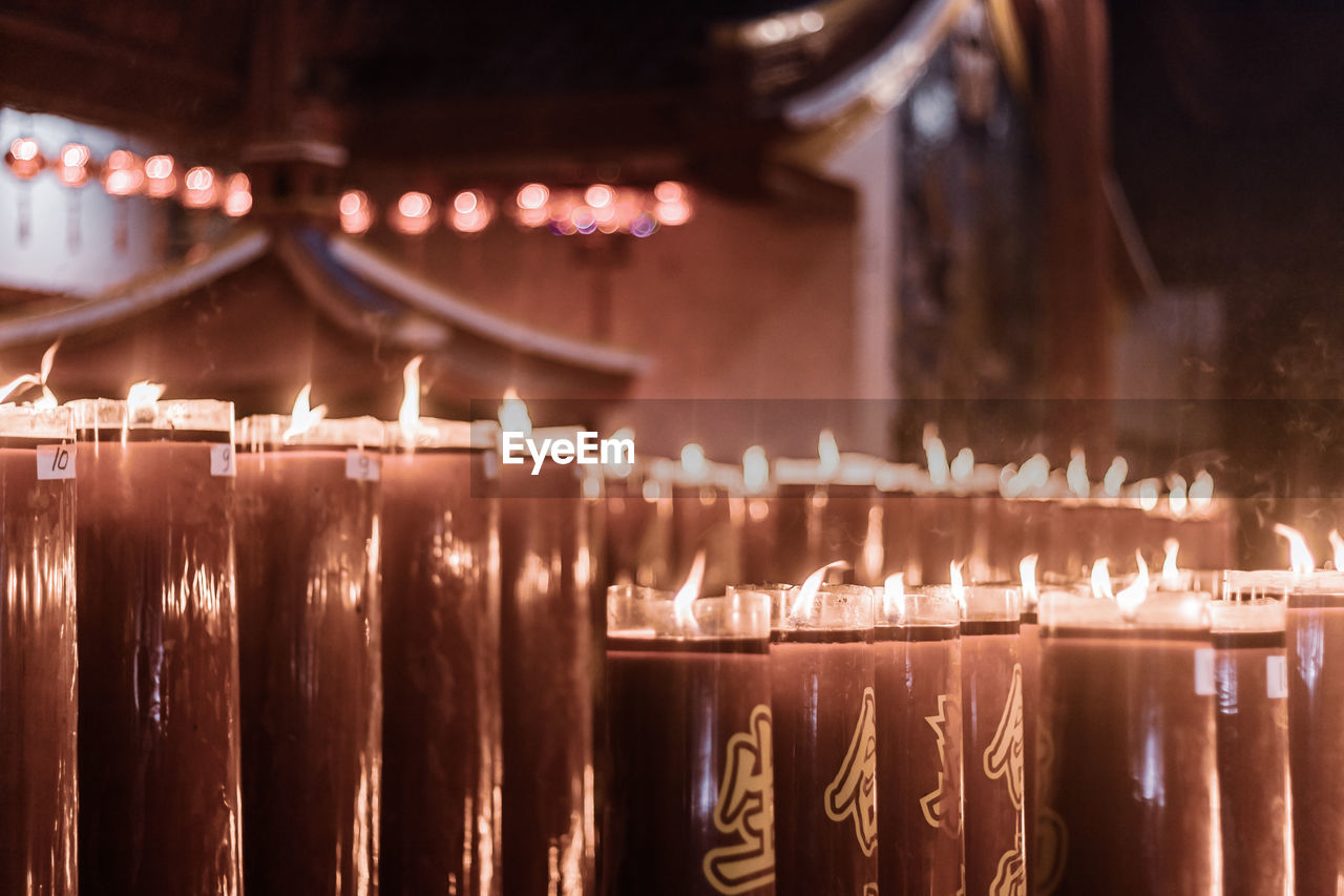 Illuminated candles in temple