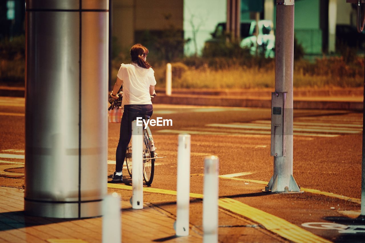 Rear view of woman on bicycle