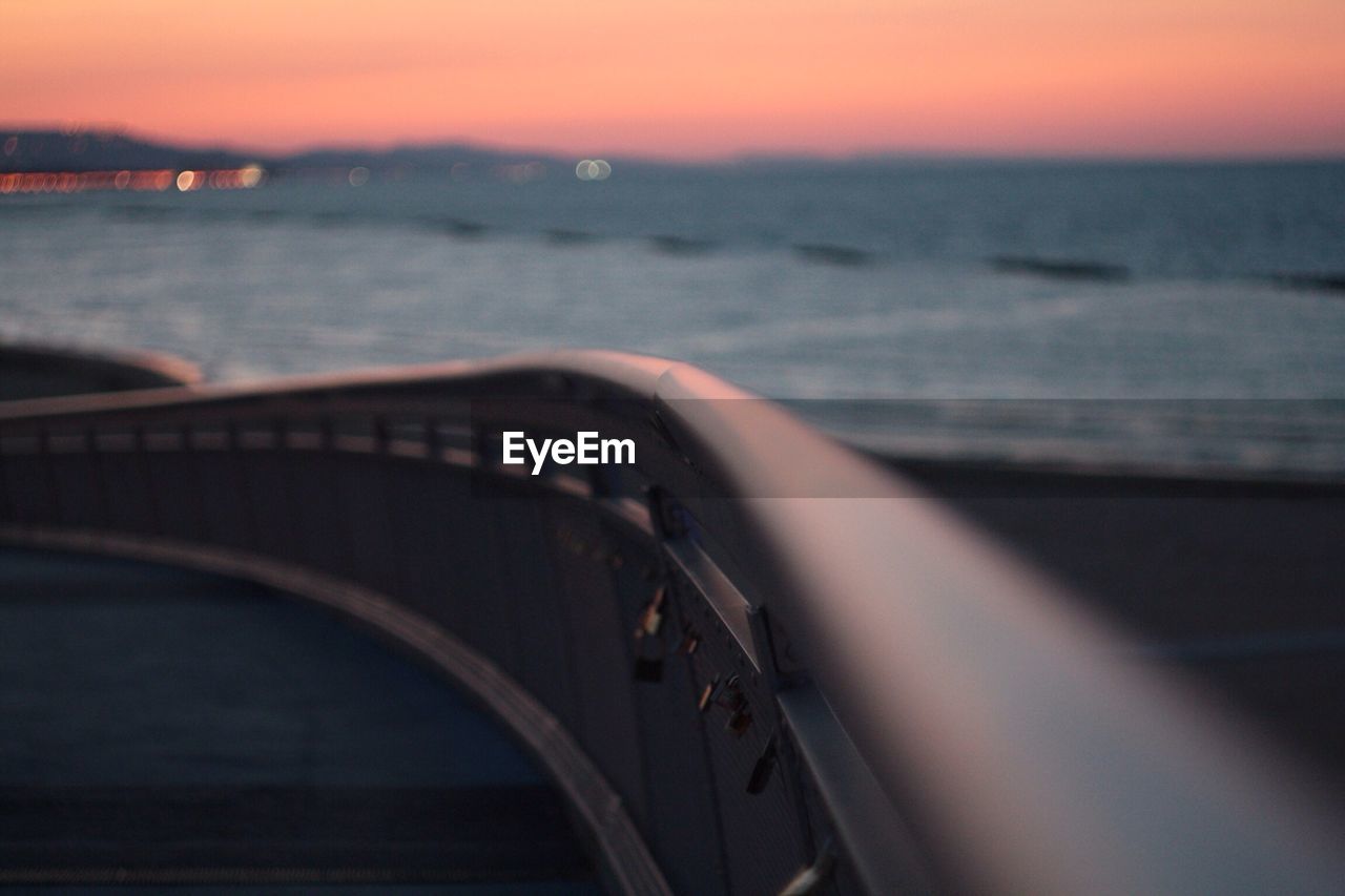 CROPPED IMAGE OF BOAT ON SEA AT SUNSET