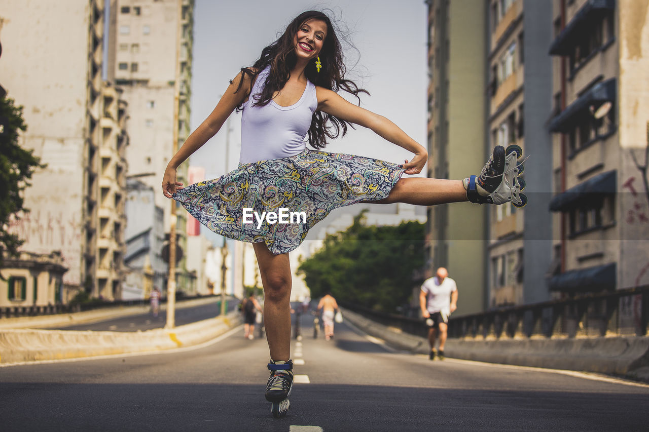 Portrait of young woman on road