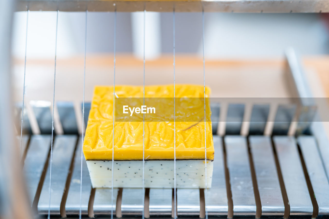 CLOSE-UP OF YELLOW JUICE ON METAL TABLE