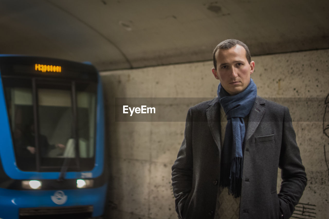 Portrait of man standing on railroad platform