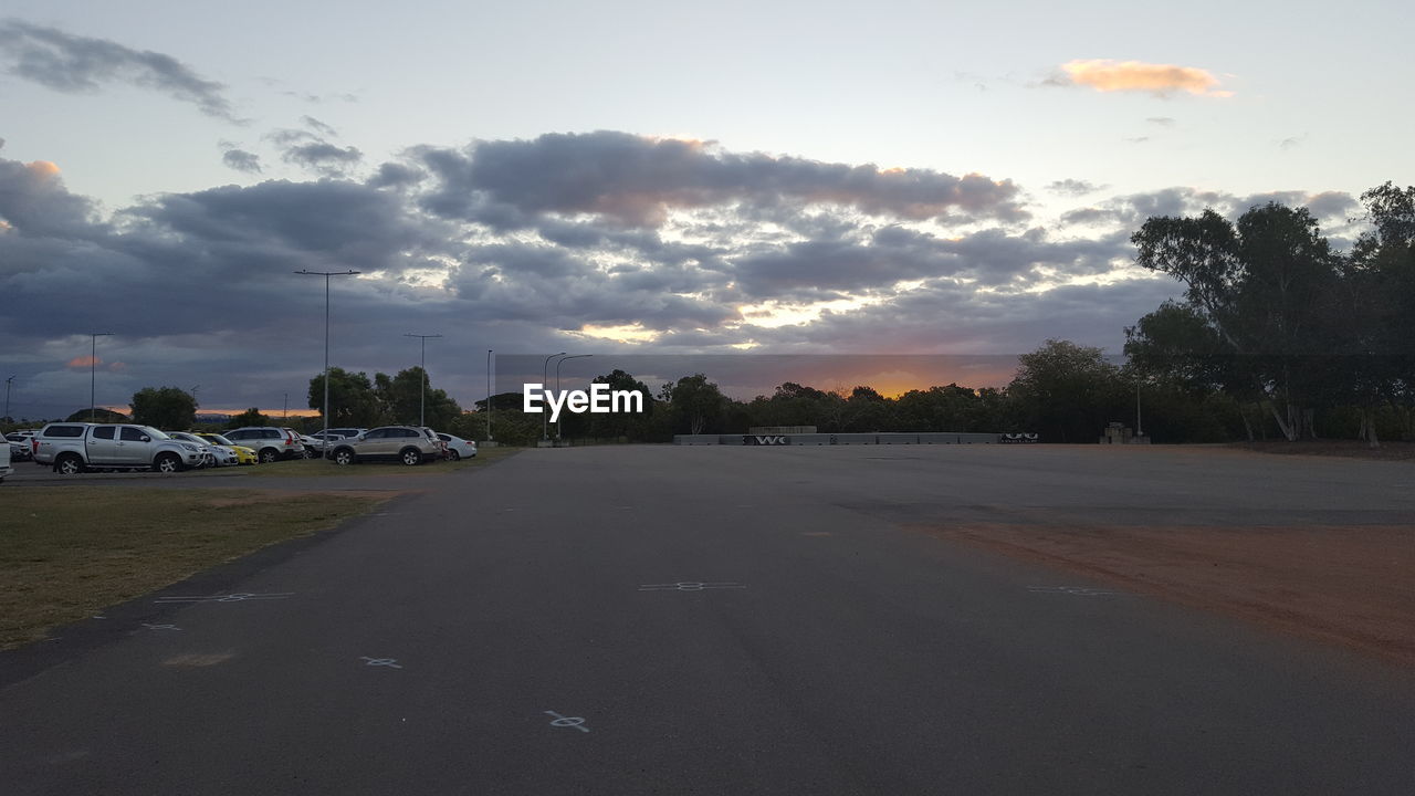 CARS ON ROAD AGAINST SKY