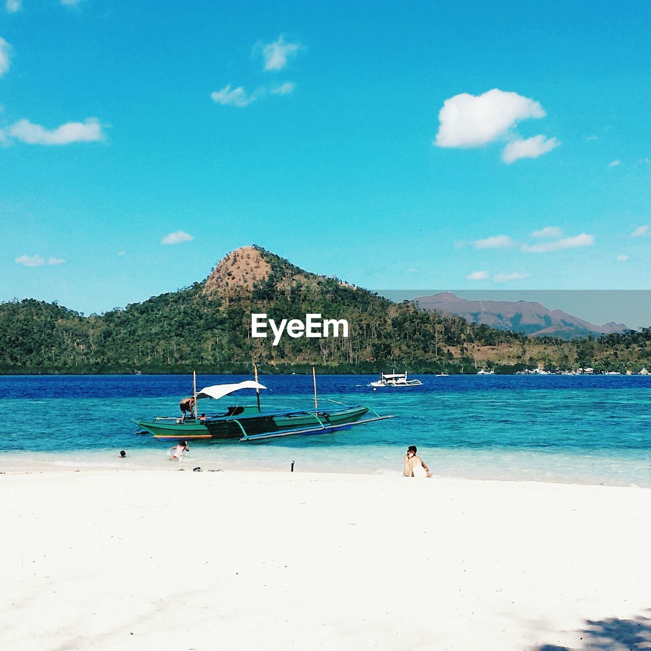 Scenic view of beach against blue sky