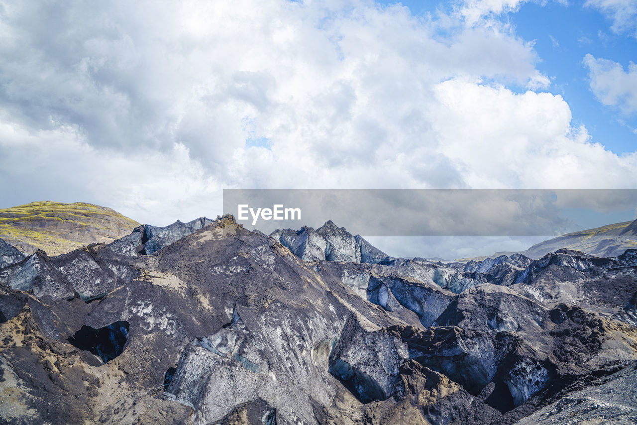 mountain, sky, cloud, environment, mountain range, scenics - nature, landscape, beauty in nature, nature, ridge, snow, rock, wilderness, travel destinations, cold temperature, adventure, travel, outdoors, no people, mountain pass, winter, plateau, blue, land, summit, day, activity, mountain peak, extreme terrain, tranquility, tourism, non-urban scene, tranquil scene, snowcapped mountain